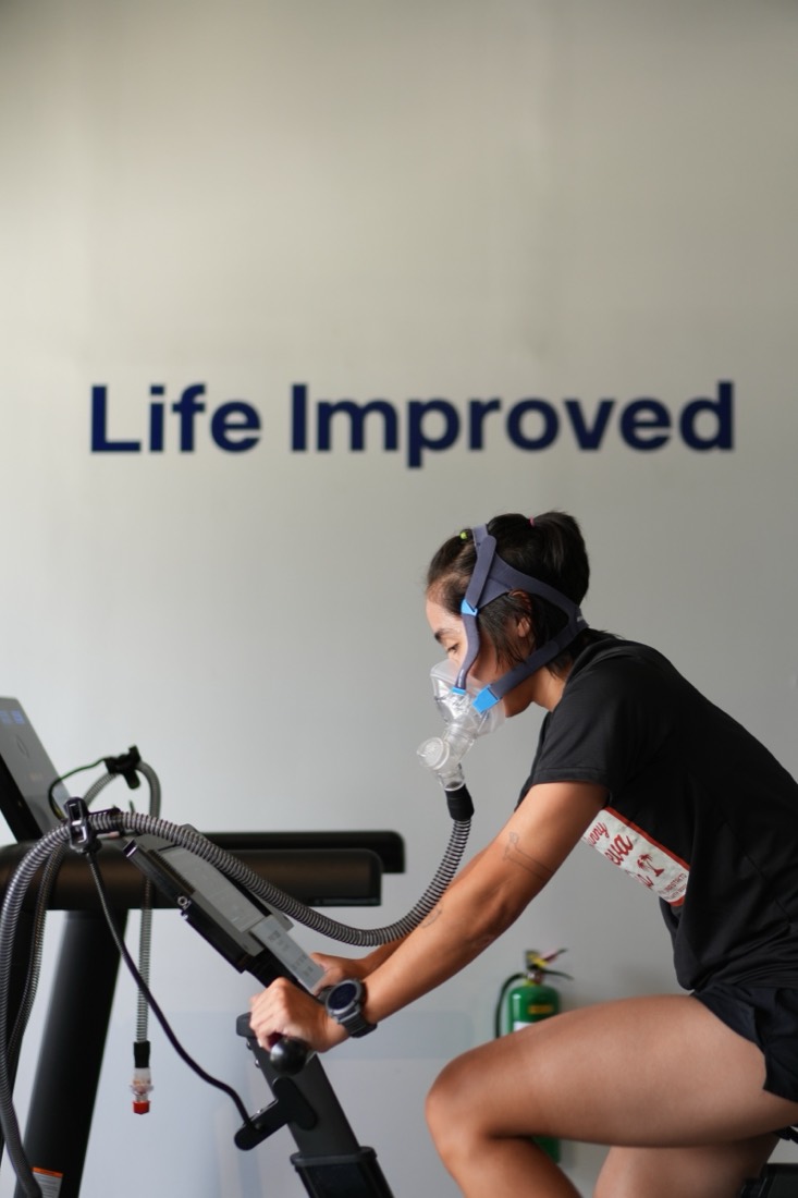 Guest on the EWOT bike with an oxygen mask